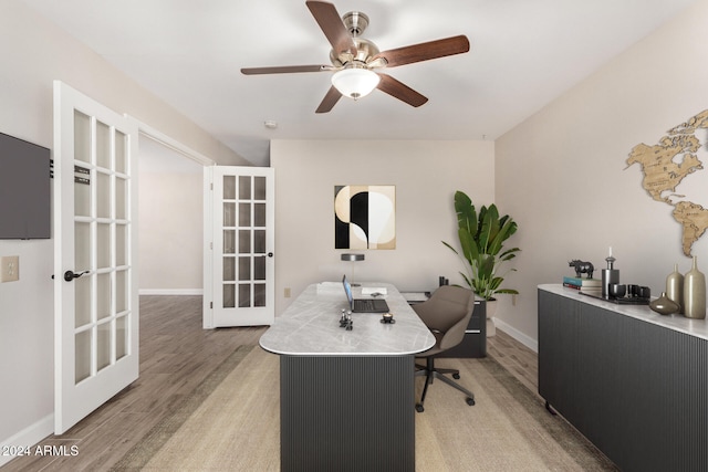 office featuring french doors, light wood-type flooring, and ceiling fan