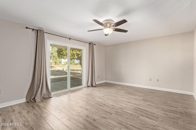 spare room with ceiling fan and light wood-type flooring