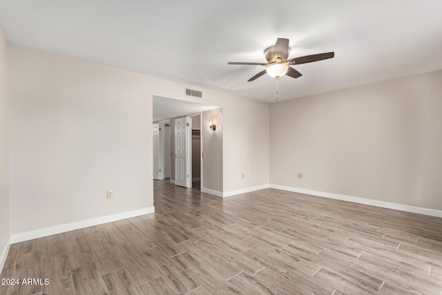 unfurnished room featuring ceiling fan and light wood-type flooring