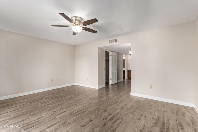 spare room featuring hardwood / wood-style flooring and ceiling fan