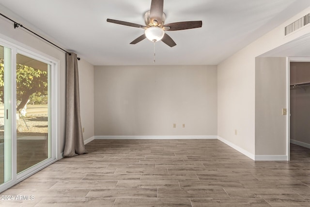 unfurnished room featuring ceiling fan and light hardwood / wood-style floors