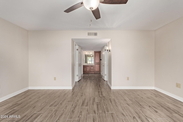 empty room featuring hardwood / wood-style flooring and ceiling fan