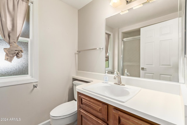 bathroom with vanity, an enclosed shower, and toilet