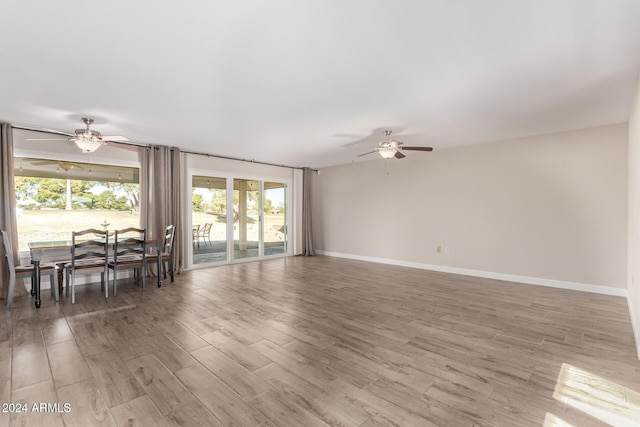 living room with ceiling fan and wood-type flooring