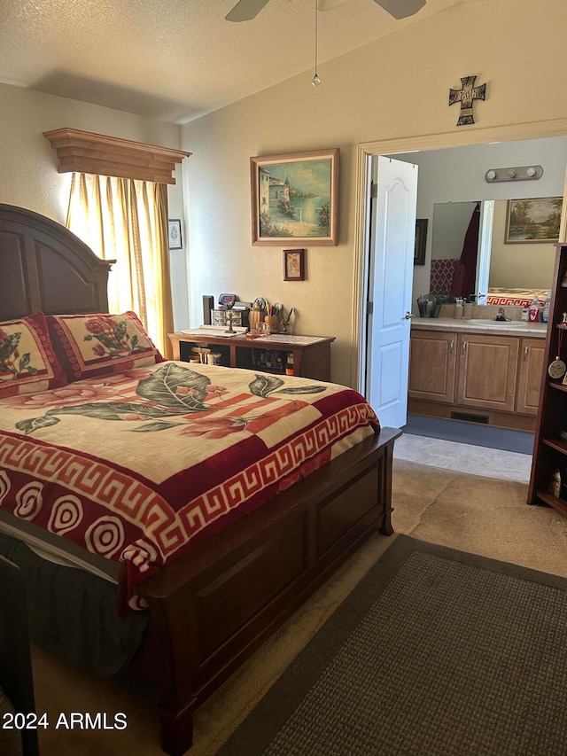 bedroom with a textured ceiling, light colored carpet, and ceiling fan