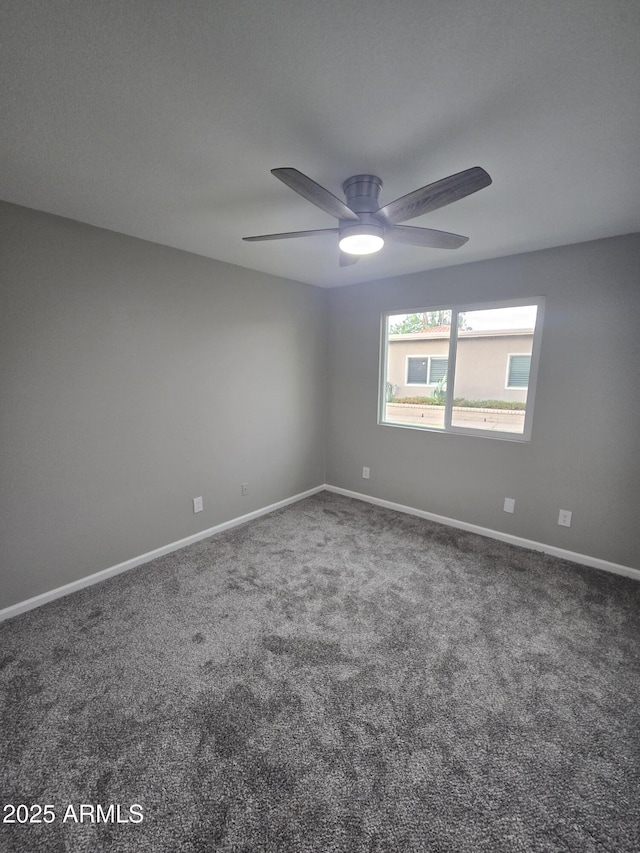 spare room featuring carpet, baseboards, and ceiling fan