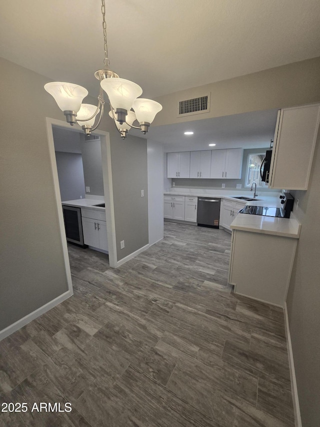 kitchen with visible vents, white cabinets, baseboards, light countertops, and stainless steel dishwasher