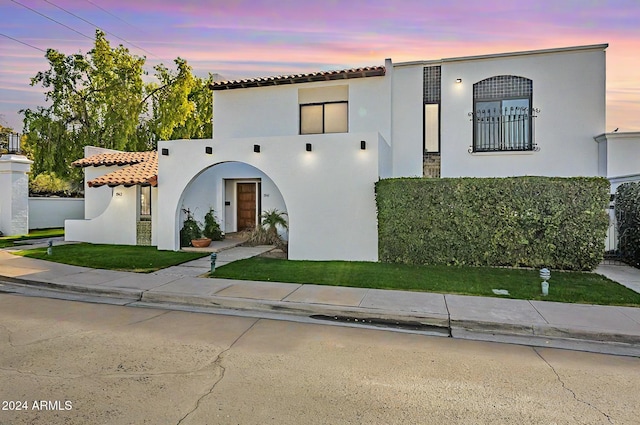 mediterranean / spanish house with a lawn