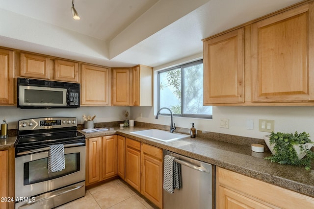 kitchen with sink, light tile patterned flooring, and appliances with stainless steel finishes