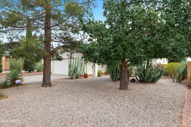 view of front of property featuring a garage, concrete driveway, and stucco siding