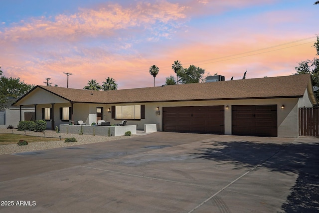 4920 E Osborn Rd, Phoenix, AZ 85018 - single story home featuring concrete driveway, an attached garage, and stucco siding