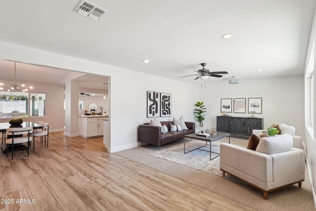 4920 E Osborn Rd, Phoenix, AZ 85018 - living area featuring light wood-type flooring, a ceiling fan, a chandelier, recessed lighting, and baseboards
