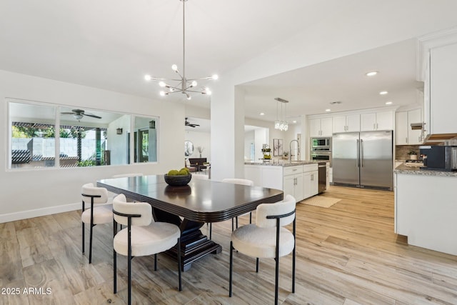 4920 E Osborn Rd, Phoenix, AZ 85018 - dining room with a chandelier, a ceiling fan, light wood finished floors, and recessed lighting