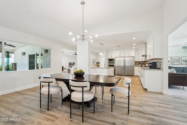 4920 E Osborn Rd, Phoenix, AZ 85018 - dining area with a chandelier, light wood finished floors, recessed lighting, a ceiling fan, and baseboards