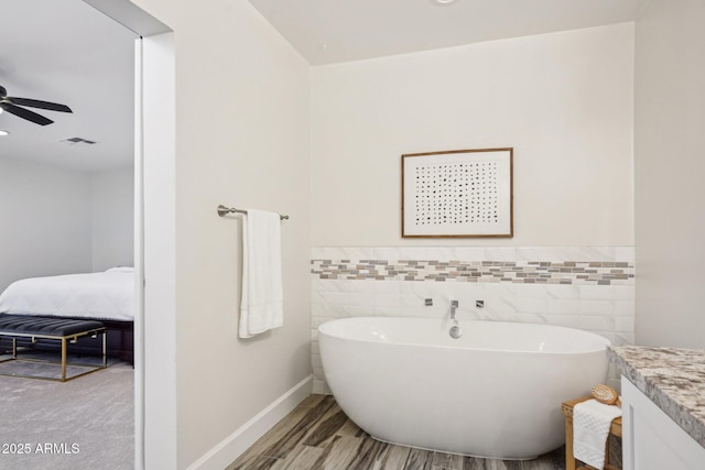 4920 E Osborn Rd, Phoenix, AZ 85018 - bathroom featuring a freestanding tub, vanity, tile walls, a ceiling fan, and wainscoting