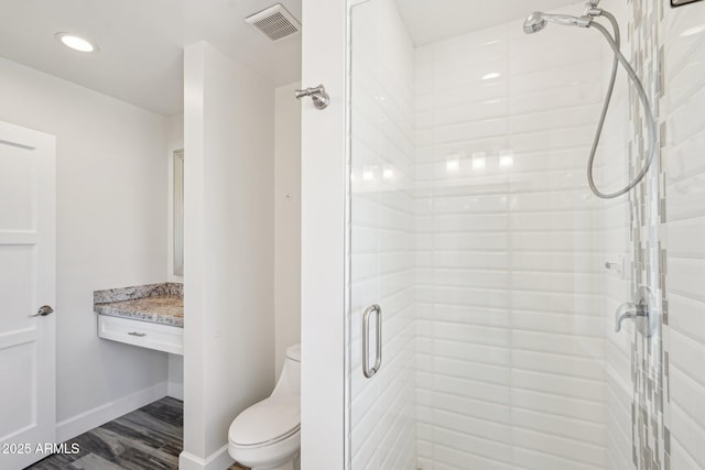 4920 E Osborn Rd, Phoenix, AZ 85018 - bathroom featuring a shower stall, toilet, baseboards, wood finished floors, and recessed lighting