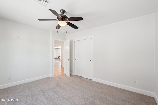 4920 E Osborn Rd, Phoenix, AZ 85018 - unfurnished bedroom with light carpet, baseboards, a closet, and ceiling fan