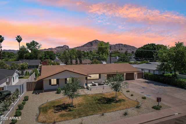 4920 E Osborn Rd, Phoenix, AZ 85018 - view of front of home featuring driveway, a mountain view, an attached garage, and stucco siding
