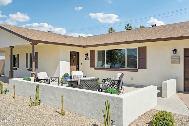 4920 E Osborn Rd, Phoenix, AZ 85018 - back of house with stucco siding, a shingled roof, an outdoor hangout area, and a patio