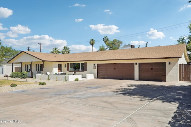 4920 E Osborn Rd, Phoenix, AZ 85018 - ranch-style house with driveway, an attached garage, and stucco siding