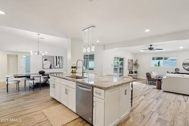 4920 E Osborn Rd, Phoenix, AZ 85018 - kitchen with stainless steel dishwasher, a sink, open floor plan, a chandelier, and white cabinets