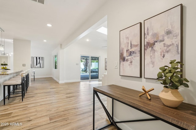 4920 E Osborn Rd, Phoenix, AZ 85018 - hall featuring light wood-style floors, recessed lighting, a chandelier, baseboards, and vaulted ceiling