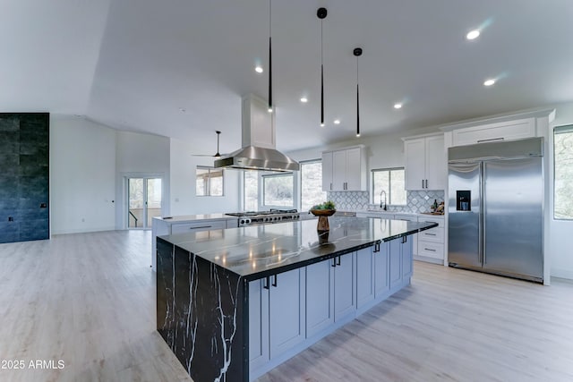 3903 E Melody Dr, Phoenix, AZ 85042 - kitchen with built in fridge, a spacious island, light wood-style flooring, healthy amount of natural light, and lofted ceiling
