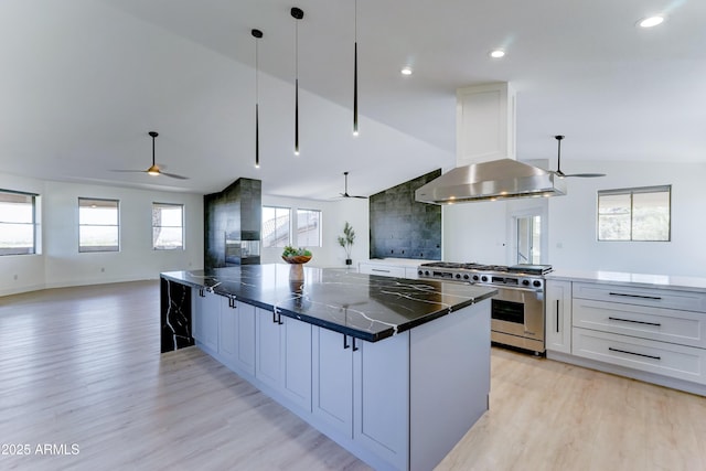 3903 E Melody Dr, Phoenix, AZ 85042 - kitchen with high end stove, ceiling fan, open floor plan, lofted ceiling, and light wood-type flooring