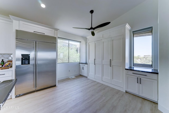 3903 E Melody Dr, Phoenix, AZ 85042 - kitchen featuring stainless steel built in refrigerator, white cabinetry, light wood-style flooring, ceiling fan, and dark countertops