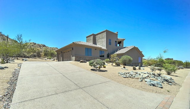 3903 E Melody Dr, Phoenix, AZ 85042 - view of home's exterior with a tile roof, stucco siding, driveway, and an attached garage