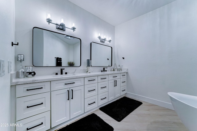 3903 E Melody Dr, Phoenix, AZ 85042 - full bath featuring double vanity, a soaking tub, baseboards, and wood finished floors