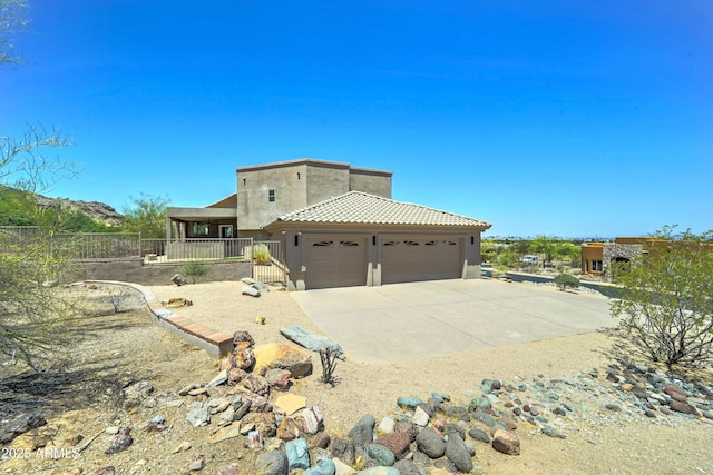 3903 E Melody Dr, Phoenix, AZ 85042 - view of front of house featuring a garage, stucco siding, concrete driveway, and a tile roof