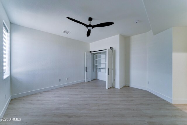 3903 E Melody Dr, Phoenix, AZ 85042 - unfurnished bedroom with wood finished floors, baseboards, and a ceiling fan