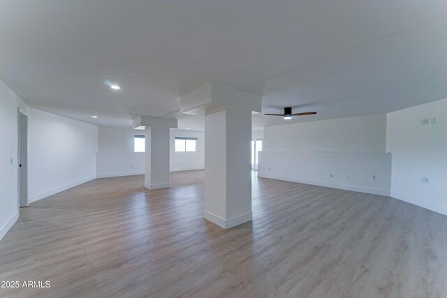 3903 E Melody Dr, Phoenix, AZ 85042 - unfurnished living room featuring baseboards, recessed lighting, and light wood finished floors