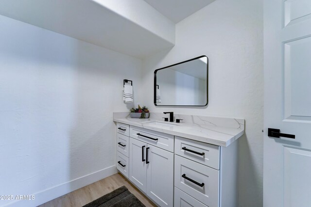 3903 E Melody Dr, Phoenix, AZ 85042 - bathroom with vanity, wood finished floors, and baseboards