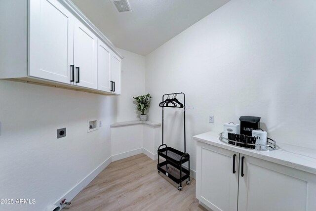 3903 E Melody Dr, Phoenix, AZ 85042 - laundry area with hookup for a washing machine, cabinet space, electric dryer hookup, light wood-style flooring, and baseboards