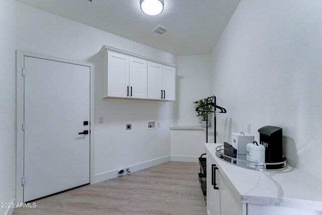 3903 E Melody Dr, Phoenix, AZ 85042 - laundry area featuring cabinet space, hookup for an electric dryer, hookup for a washing machine, light wood finished floors, and baseboards