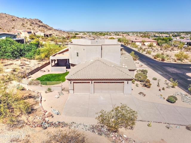 3903 E Melody Dr, Phoenix, AZ 85042 - view of front facade featuring concrete driveway, a tiled roof, stucco siding, and a mountain view