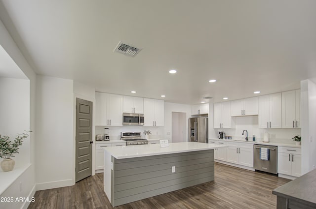 kitchen featuring stainless steel appliances, sink, and white cabinets