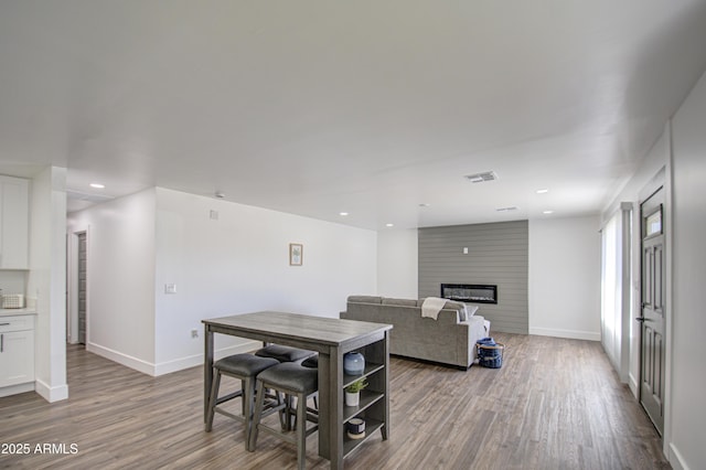 interior space with a fireplace and light hardwood / wood-style flooring