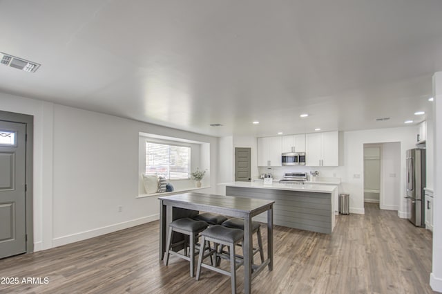 dining room with wood-type flooring and radiator heating unit