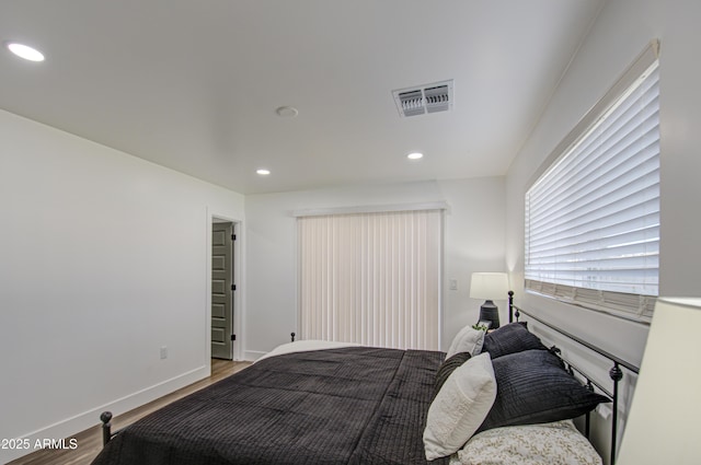 bedroom with wood-type flooring