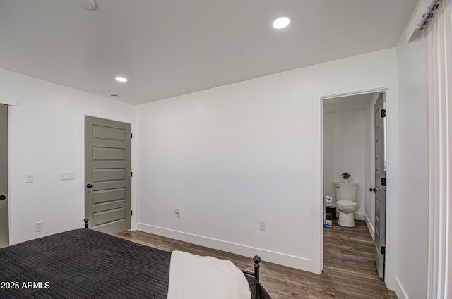 unfurnished bedroom with dark wood-type flooring and ensuite bathroom