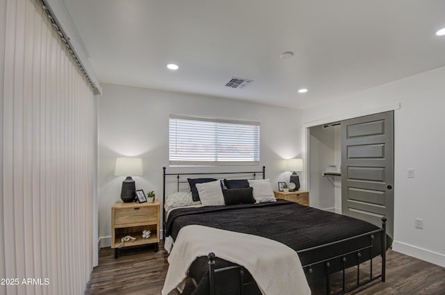 bedroom with dark hardwood / wood-style flooring