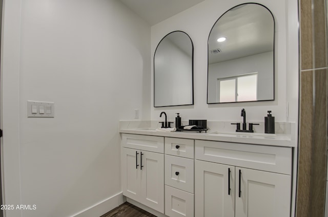 bathroom with vanity and wood-type flooring