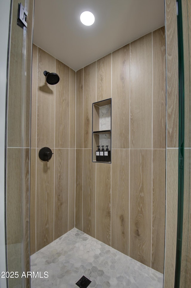 bathroom with tiled shower