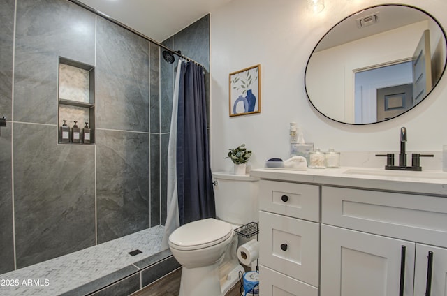 bathroom featuring vanity, wood-type flooring, toilet, and walk in shower