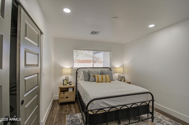 bedroom with dark hardwood / wood-style floors