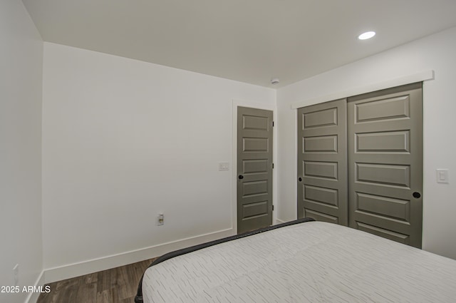 bedroom featuring wood-type flooring and a closet