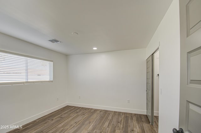 unfurnished room featuring wood-type flooring